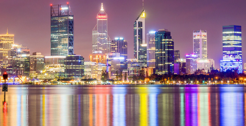 Perth city skyline from the South Perth foreshore. Perth, Western Australia, Australia. Photo taken at night. All the city lights are reflecting off the water.