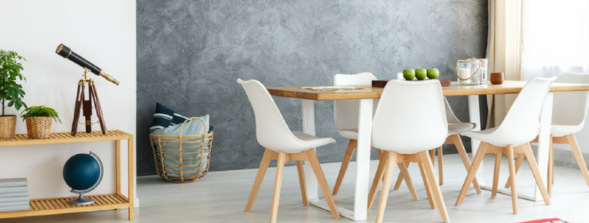 Small wooden table with telescope books and potted plants in modern dining room