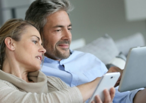 couple_looking_at__their_tablet_web_looking_for_real_estate_agents